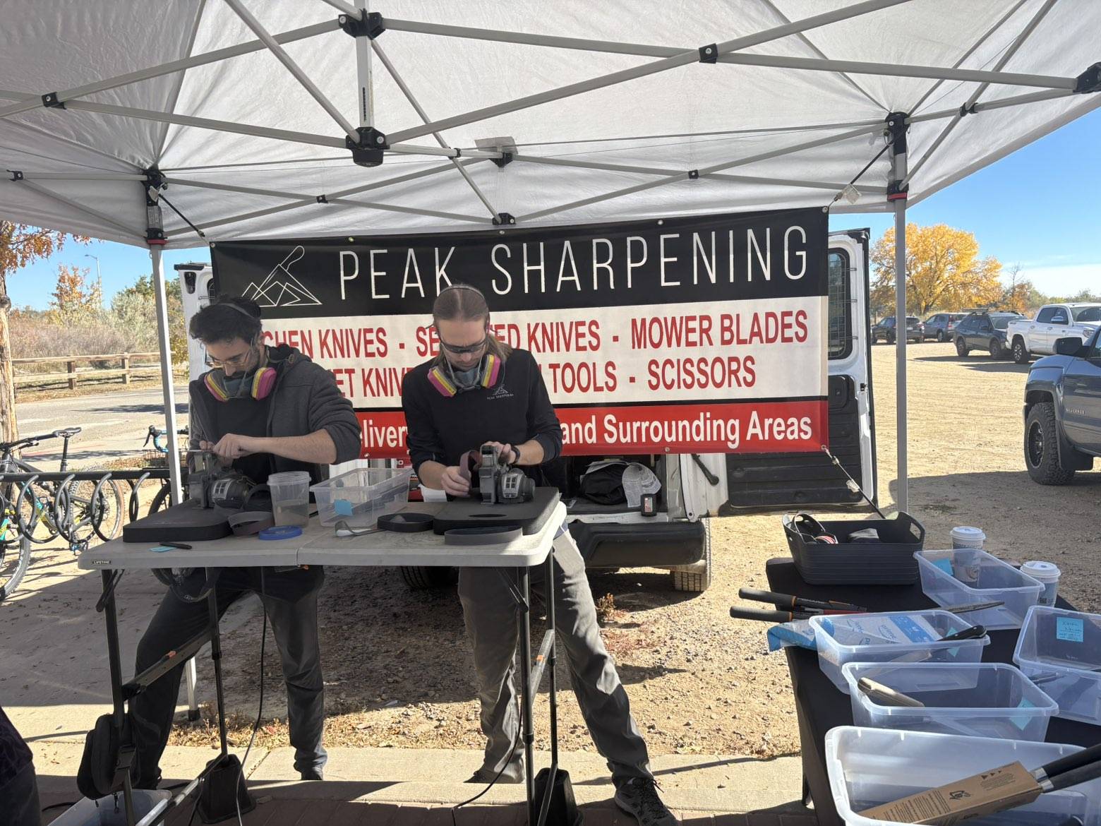Jacob and Ben sharpening knives at a local farmers market